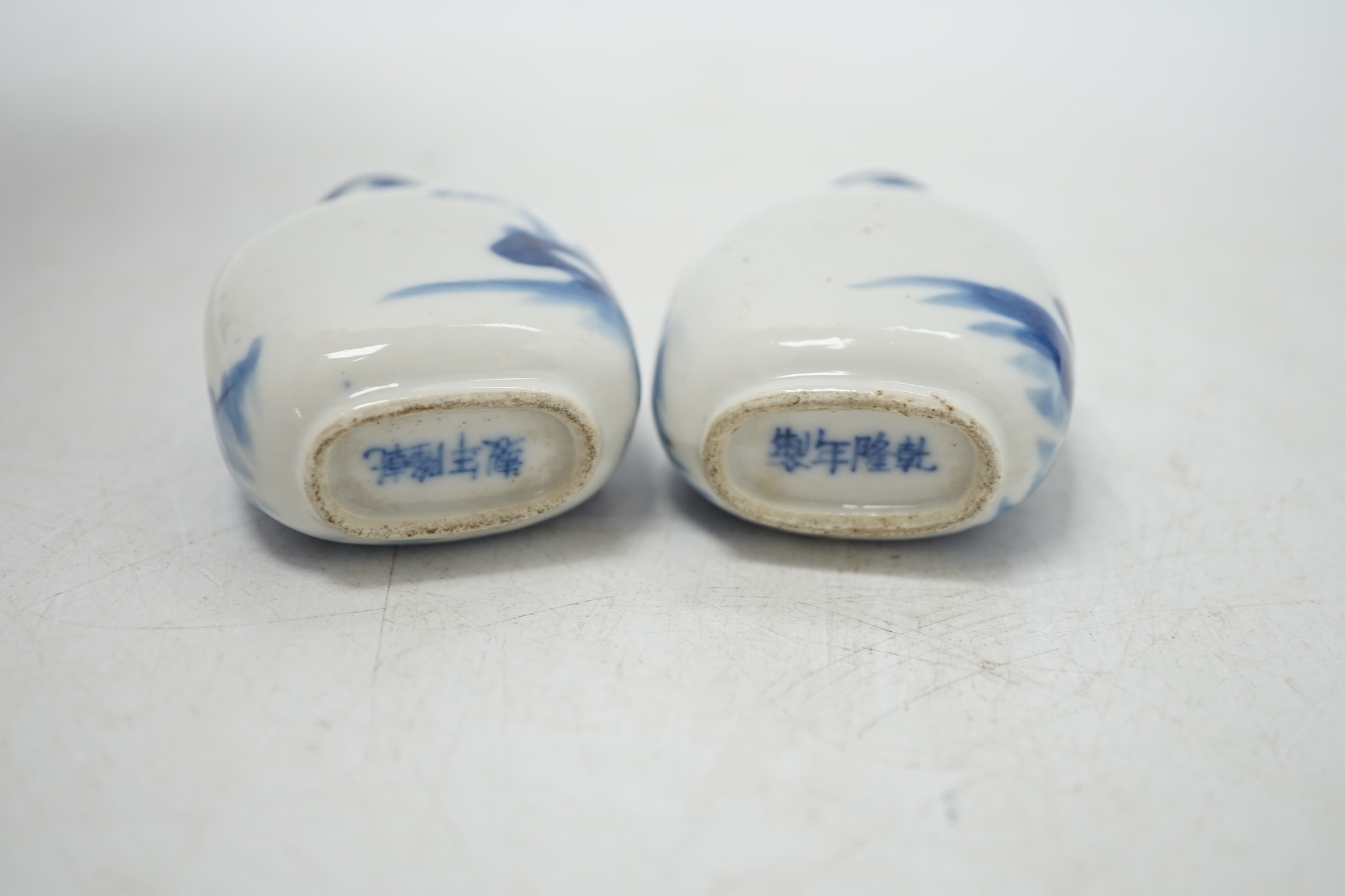 Two Chinese blue and white snuff bottles decorated with figures, largest 6cm high. Condition - fair